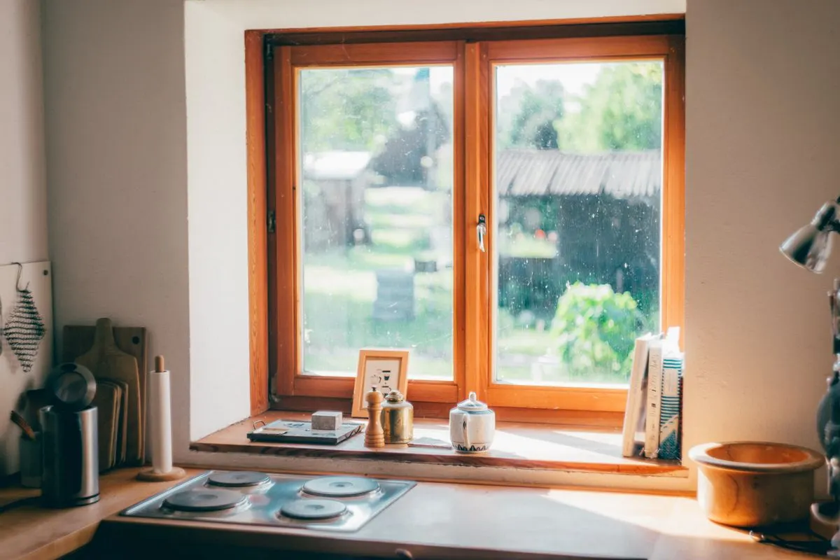 Sunlit kitchen with a table and a window looking out to greenery