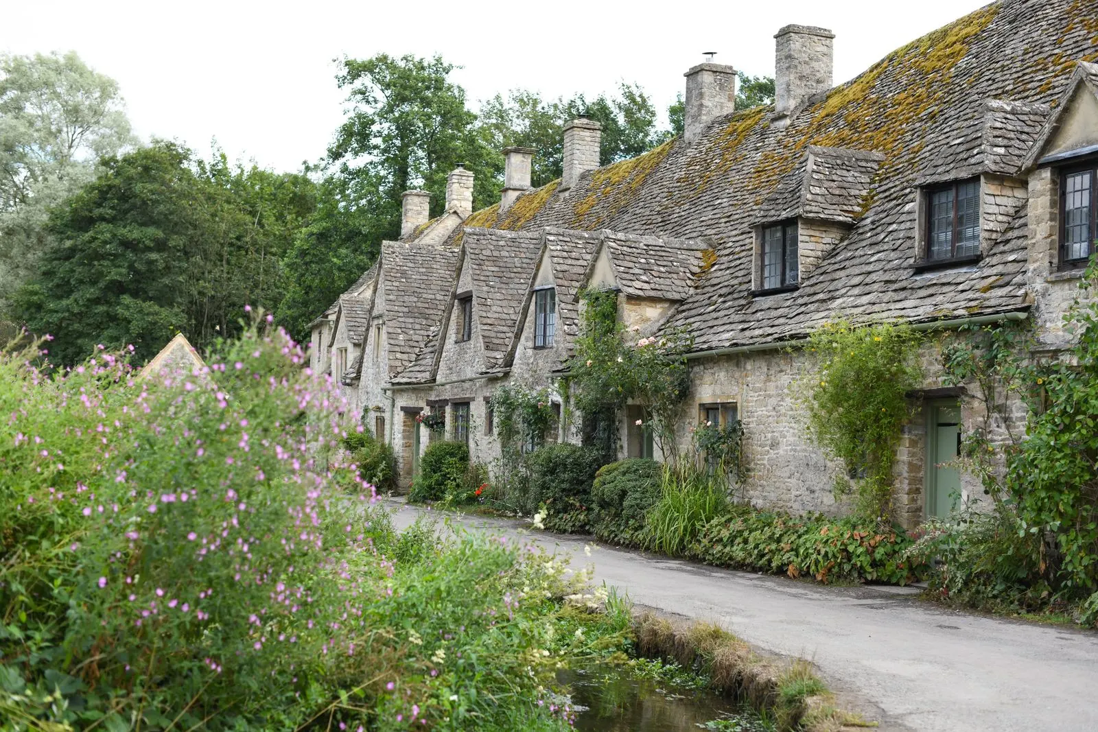 Stone houses with front gardens on a village street in England